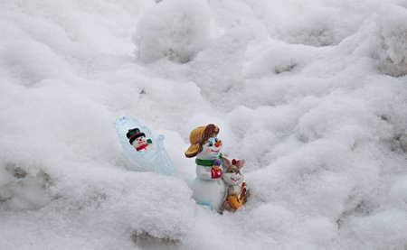Children's Christmas tree decorations go on deep snow home after Christmas holidays.の写真素材