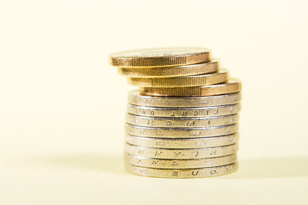 Pile of coins on yellow surface