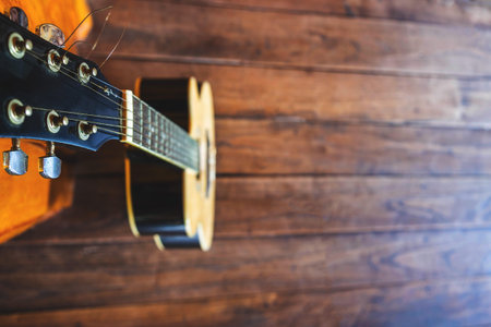 Acoustic guitar placed on wooden floors