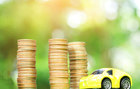 Car and coin natural blurred background Concept of car insurance