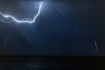 Bolt of lightening in a night sky during a thunderstorm with copy space in a weather or meteorology concept