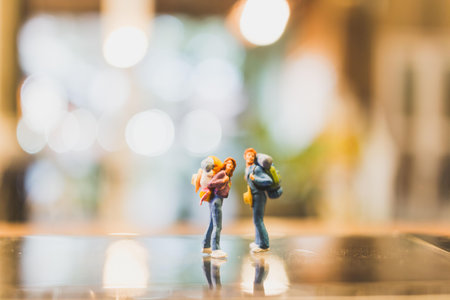 Miniature Backpacker , Tourist people standing on glass with blurred background