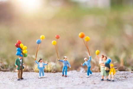 Miniature people : Happy family with balloons , Happy family relations and carefree leisure time Concept