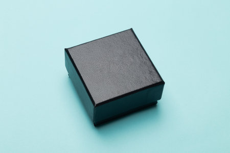Mini black box product packaging isolated on blue background.