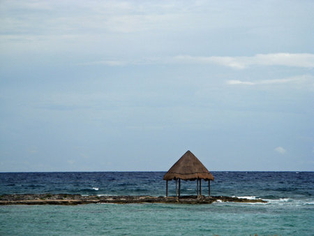 Palapa out on a rocks edge, Mexicoの写真素材