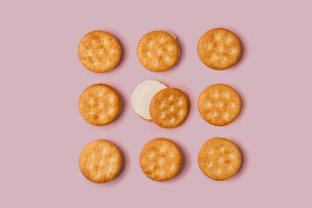 Creative Concept Tasty Biscuit Cheese Flavour on Pink Backgroundの写真素材