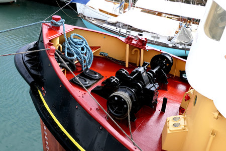 Tugboat winch and ropes situated at the prow end of the shipの写真素材