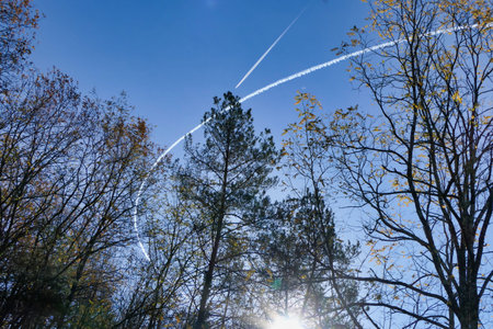 Vortex trails from a jet aircraft performing fast aerial manoeuvres over the Dordogne countryside