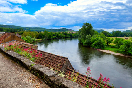 View of the River Dordogne flowing through the landscape as seen from Beynac et Cazenac a fortified town in the Dordogne, Franceの写真素材