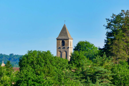 Steeple poking through the trees of the medieval Church of Plazac in the Perigord Noir, Dordogne, Franceの写真素材