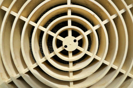 Old external grill cover connected to an extractor extracting steam and fumes from a kitchen cookerの写真素材