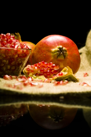 Pomegranate (Punica granatum) fruit o natural sheetの写真素材