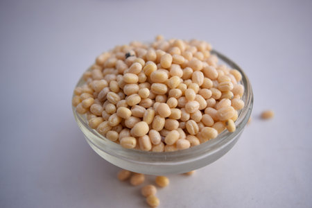 Peeled Black Gram Dal/Black Beluga Lentils in A Glass Bowl on White Background Close-Up Stock Photograph Imageの写真素材