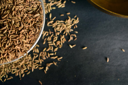 Cumin seeds in a bowl on a black background. Selective focus.の写真素材