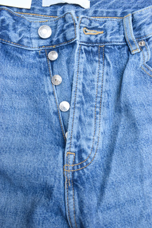 Close Up Of Blue Jean Steel Button And Zip Fabric Texture Background