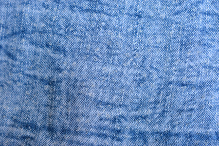 Folded Blue Denim Shirt Fabric Texture Close Up Backgroundの写真素材