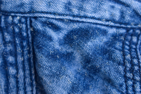 Folded Blue Denim Shirt Fabric Texture Close Up Backgroundの写真素材