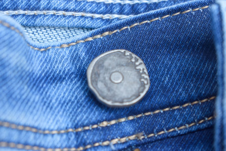 Close Up Of Blue Jean Steel Button And Zip Fabric Texture Backgroundの写真素材