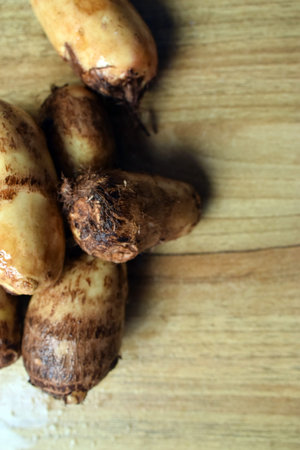 Group Of Taro Root Vegetable On Wooden Table Close Up  Image