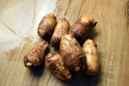 Group Of Taro Root Vegetable On Wooden Table Close Up  Imageの写真素材