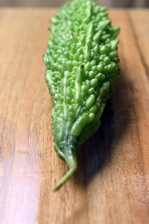 Green Vegetable Bitter Melon Or Bitter Gourd On Wooden Table Imageの写真素材