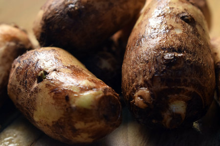 Group Of Unpeeled Taro Root Vegetable On Wooden Table  Image