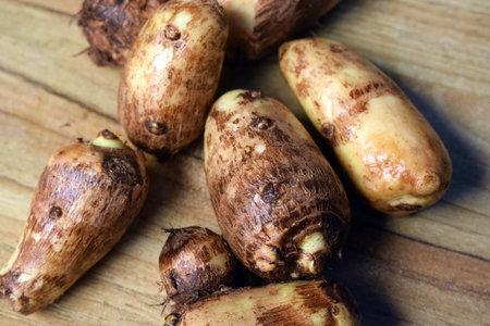 Group Of Unpeeled Taro Root Vegetable On Wooden Table  Imageの写真素材
