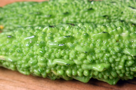 Green Vegetable Bitter Melon Or Bitter Gourd On Wooden Table Imageの写真素材