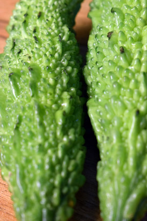Green Vegetable Bitter Melon Or Bitter Gourd On Wooden Table Imageの写真素材