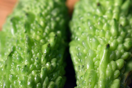 Fresh Green Bitter Melon Or Bitter Gourd On Wooden Table Close Up With Background Blur Imageの写真素材