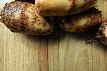 Group Of Taro Root Vegetable On Wooden Table Close Up  Imageの写真素材