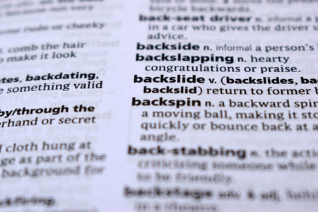 Close Up Of English Dictionary Page With Definition Word - Backslide     Image