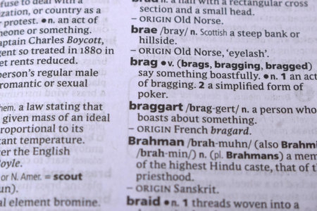 English Definition Dictionary Page Close Up Of Printed Word Of -Braggart