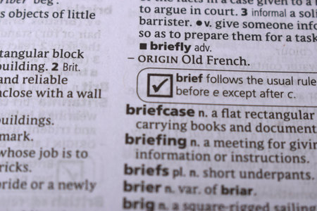 Close Up Of English Dictionary Page With Word - Briefly