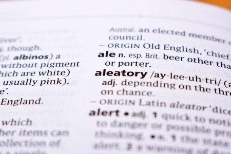 Close Up Of English Dictionary Page With Word - aleatory