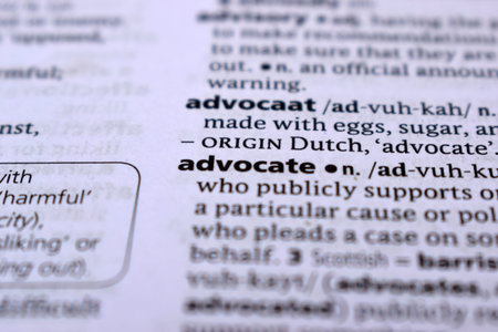 Close Up Of English Dictionary Page With Word - Advocate