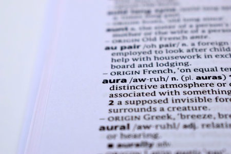 Close Up Of English Dictionary Page With Word - aura