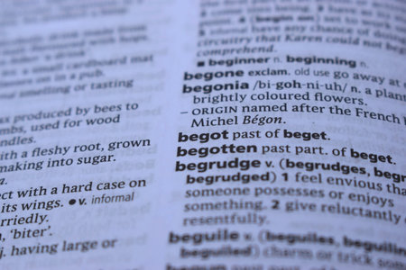 Close Up Of English Dictionary Page With Word - begotten