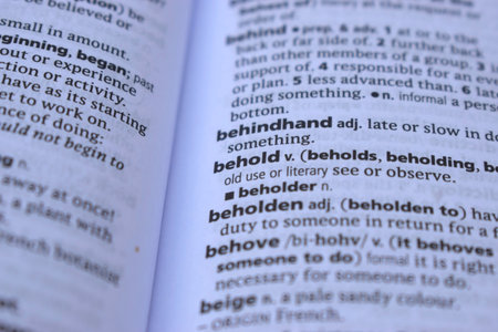 English Definition Dictionary Page Close Up Of Printed Word Of -beholdの写真素材