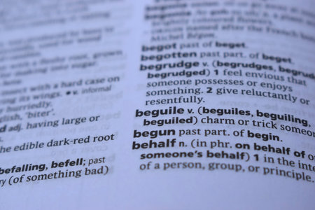 English Definition Dictionary Page Close Up Of Printed Word Of - beguile