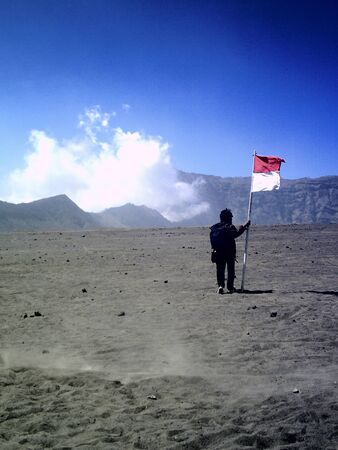 man with the flag in the desertのeditorial素材