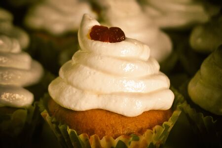 Old styled analog foto view of cupcake with cream and dry cherry on blur backgroundの写真素材