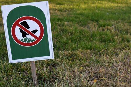Sign Dont Walk On Grass in public park on greenの写真素材