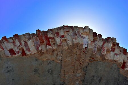 View of bright light under ancient ruined brick tunnelの写真素材