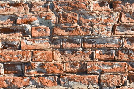 Background - old red brick wall with some ruined bricks - very close viewの写真素材