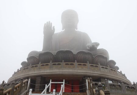 Giant Buddha in the mist at Hong Kongの写真素材
