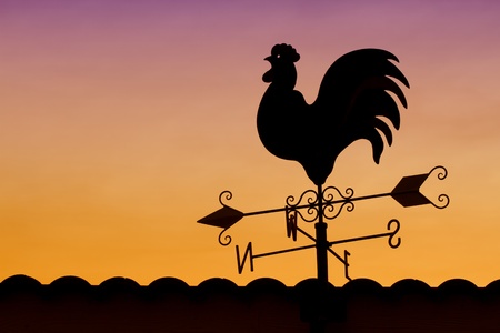 Weather Vane in Colorful Sky の写真素材