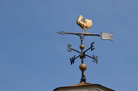Weather vane  against a  blue sky