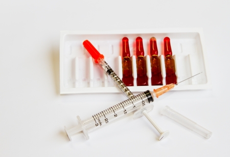 medical ampules and a syringes on white backgroundの写真素材