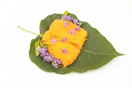 golden threads thai dessert ,thai sweets on green leaf  ,made form egg  yoke  cooked in syrupの写真素材
